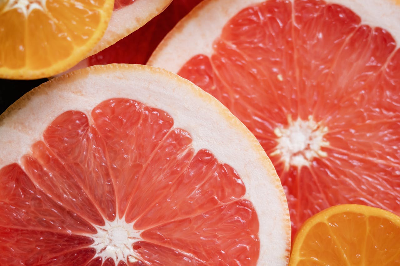 Detailed image of grapefruit and orange slices showcasing their fresh and vibrant colors.